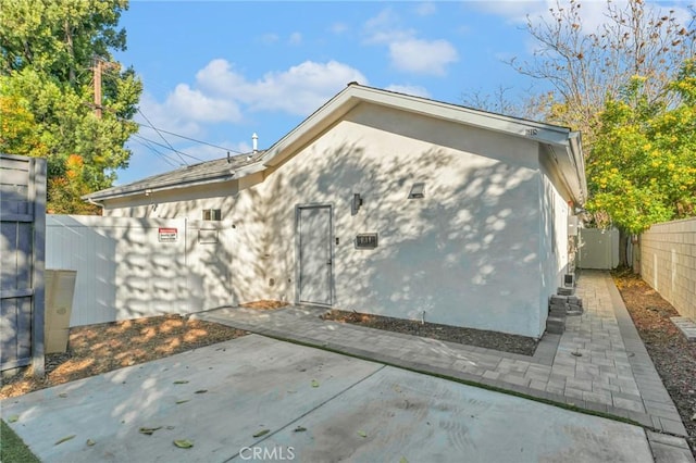 view of side of home with a patio area