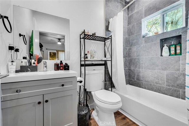 full bathroom featuring vanity, hardwood / wood-style floors, shower / bath combination with curtain, and toilet