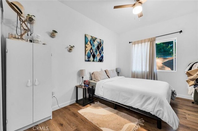 bedroom with wood-type flooring and ceiling fan