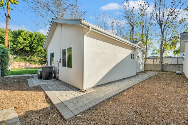 view of property exterior featuring central air condition unit and a patio area