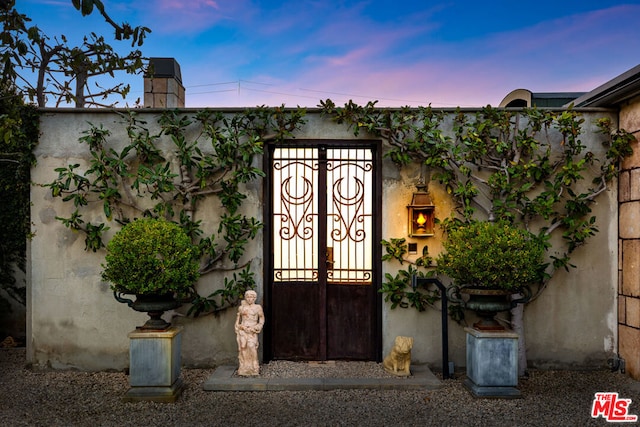 view of exterior entry at dusk