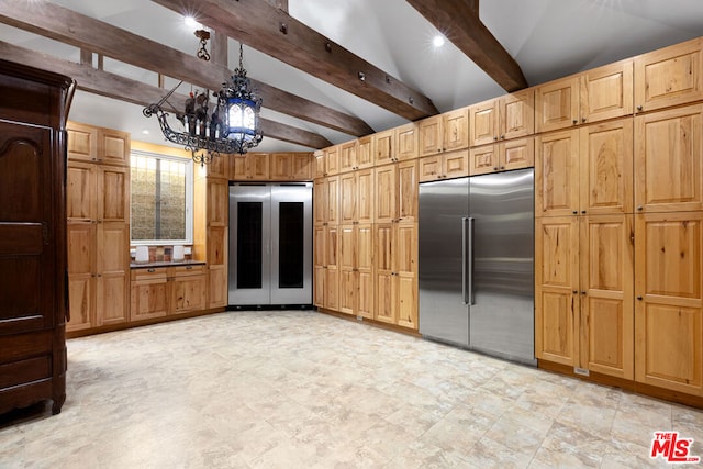 kitchen featuring pendant lighting, built in refrigerator, and vaulted ceiling with beams