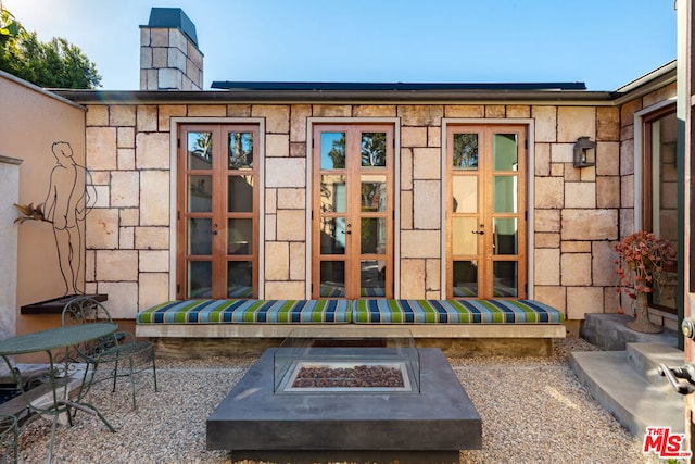 exterior space with french doors and a fire pit