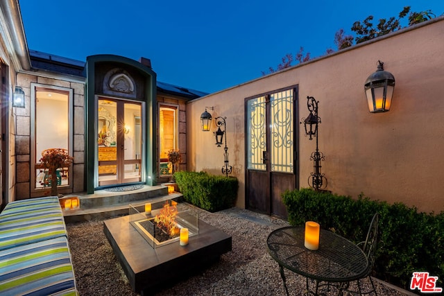 view of patio featuring an outdoor fire pit and french doors