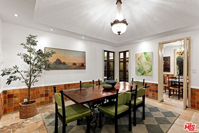 dining space featuring a notable chandelier and a textured ceiling