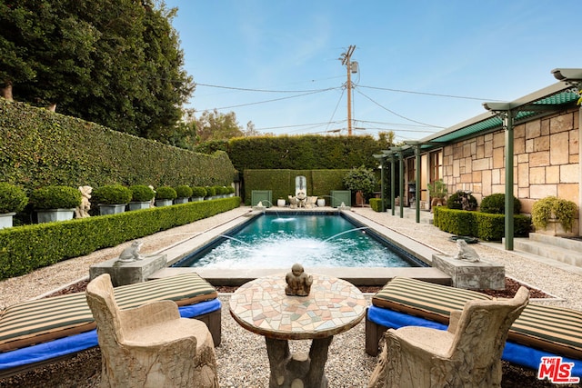 view of swimming pool with a patio and pool water feature