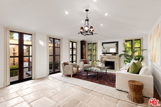 living room with a notable chandelier and french doors