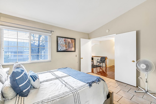 bedroom with lofted ceiling and light hardwood / wood-style flooring