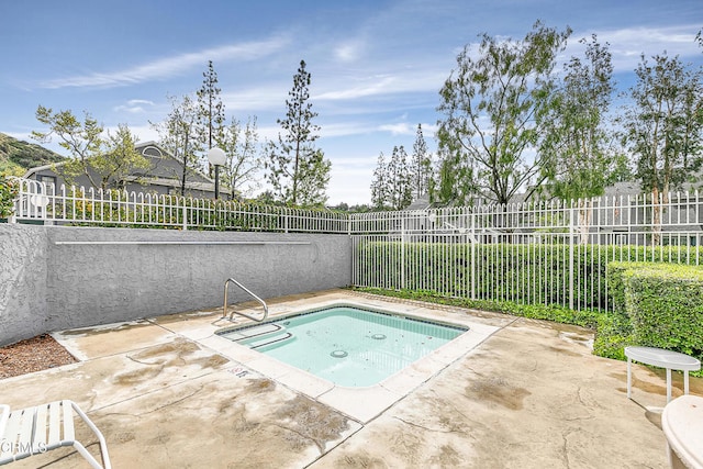 view of pool with an in ground hot tub