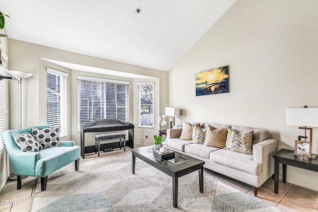 tiled living room featuring plenty of natural light and high vaulted ceiling