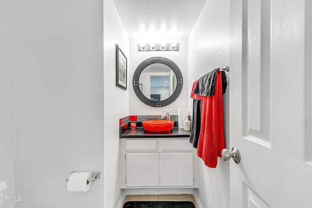 bathroom featuring a textured ceiling, vanity, and tile patterned floors