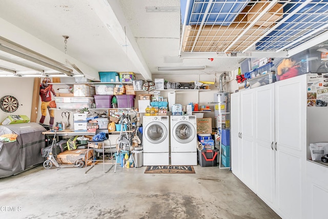 garage featuring secured water heater and washer and dryer