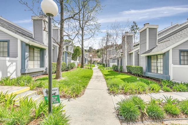 view of property's community featuring a lawn