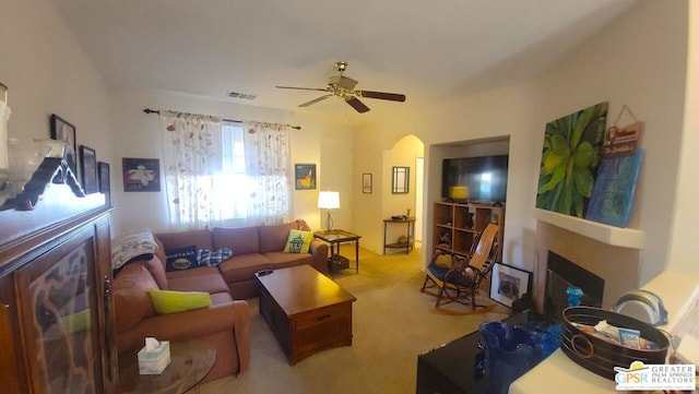 living room with ceiling fan and carpet floors