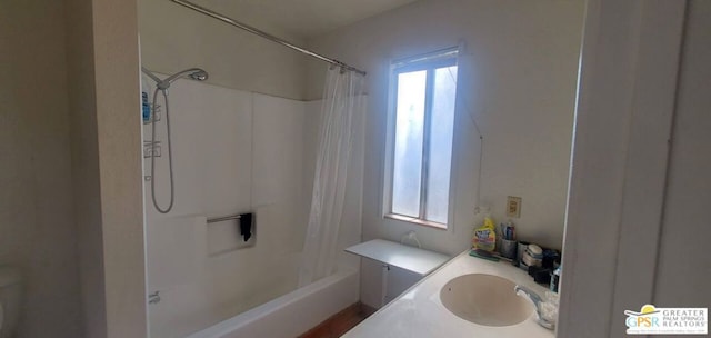 bathroom featuring vanity, shower / tub combo with curtain, and a wealth of natural light