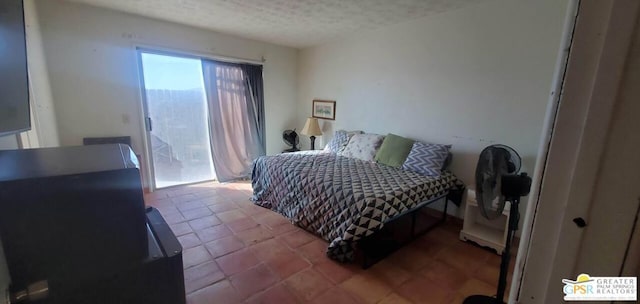 tiled bedroom with a textured ceiling