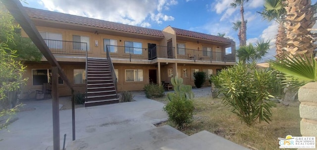 back of property featuring a balcony