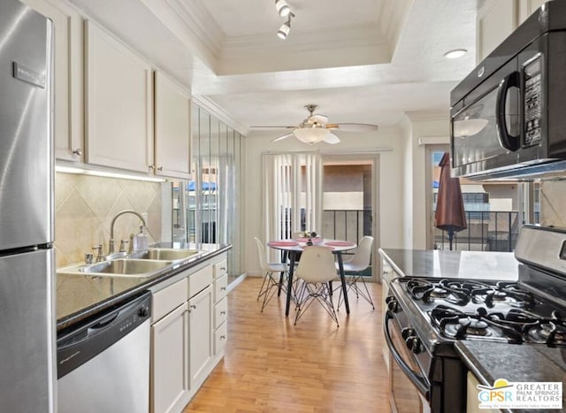 kitchen featuring black appliances, light hardwood / wood-style floors, white cabinetry, and sink