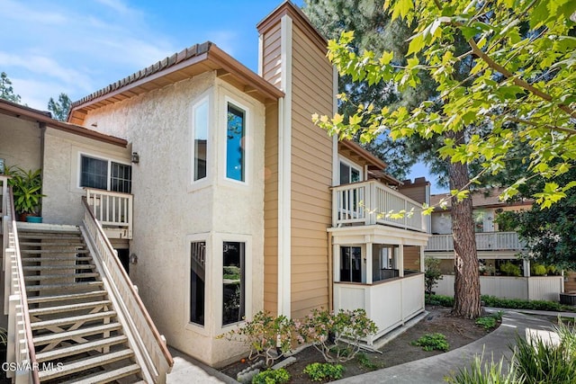 view of side of home with a balcony