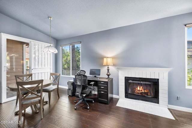 office featuring lofted ceiling, radiator, a textured ceiling, a fireplace, and dark hardwood / wood-style flooring