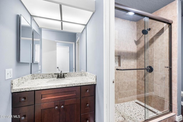 bathroom with vanity, an enclosed shower, and toilet