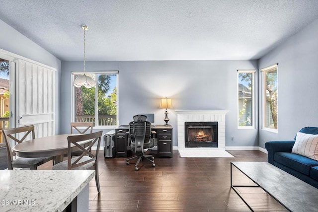 office area featuring a textured ceiling, dark hardwood / wood-style floors, and a wealth of natural light