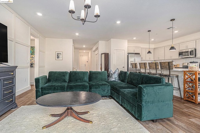 living room featuring hardwood / wood-style flooring and a notable chandelier