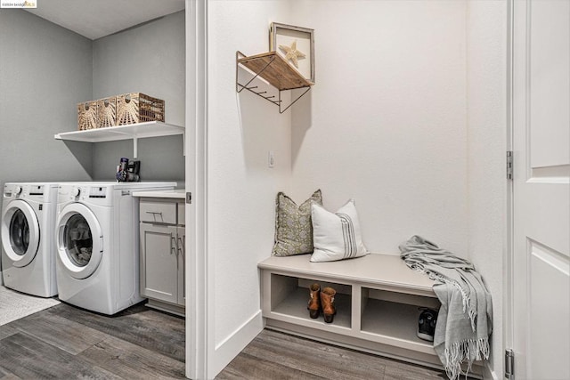 washroom featuring cabinets, dark wood-type flooring, and washing machine and dryer