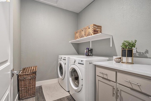 washroom with cabinets, washer and clothes dryer, and hardwood / wood-style flooring