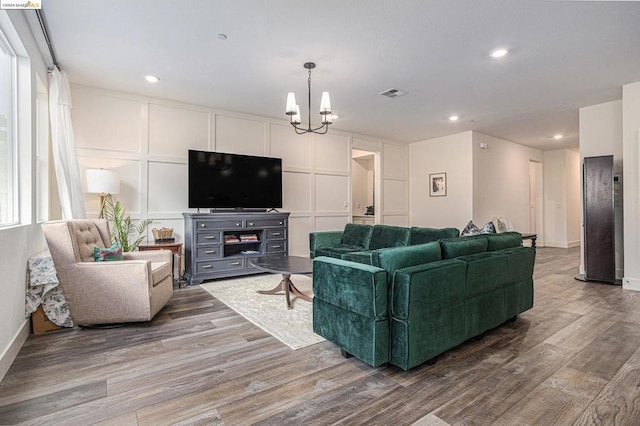 living room featuring hardwood / wood-style floors and a chandelier