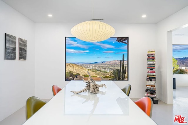 dining area with concrete flooring