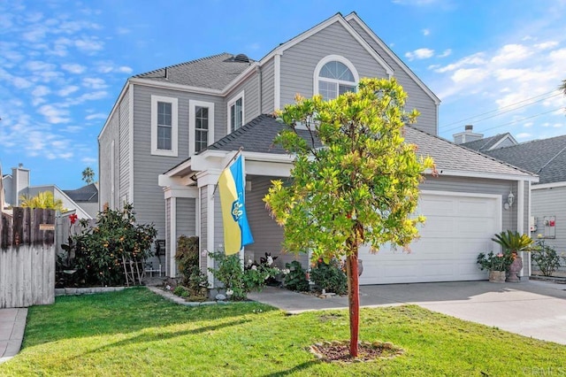 view of property featuring a garage and a front yard