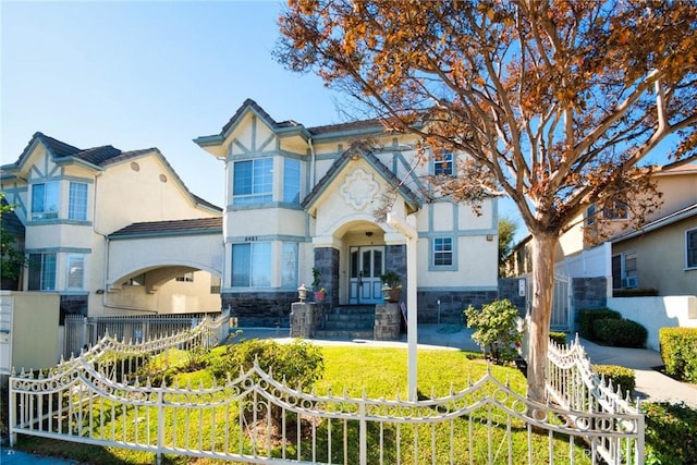 english style home with a front lawn