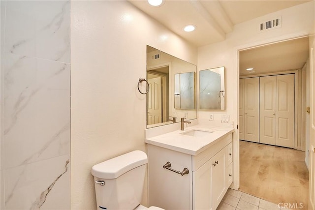 bathroom with vanity, wood-type flooring, and toilet