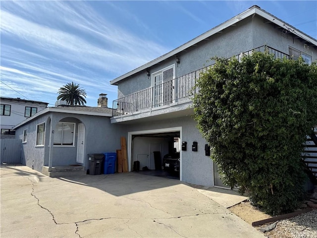 view of front of house featuring a balcony and a garage