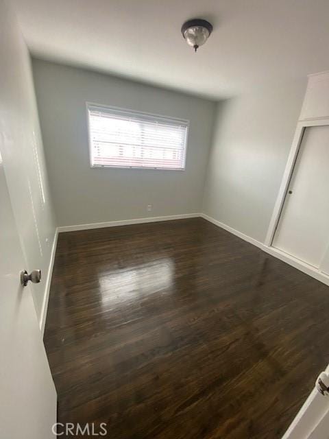 spare room featuring dark hardwood / wood-style floors