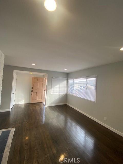 empty room with dark wood-type flooring