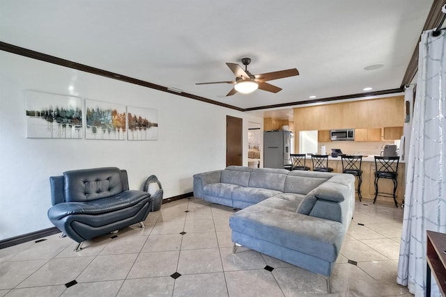 tiled living room with ceiling fan and crown molding