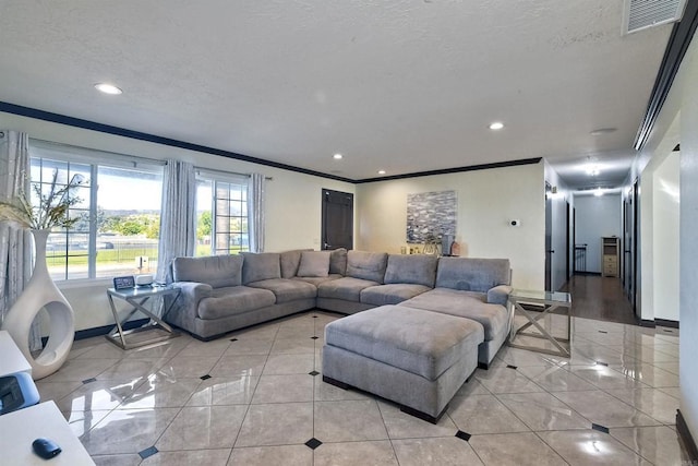 living room featuring light tile patterned floors, a textured ceiling, and ornamental molding