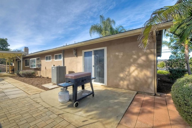 back of property with cooling unit and a patio area