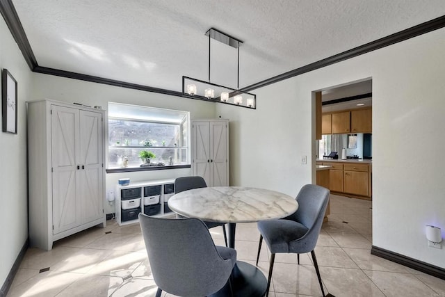 tiled dining area with a textured ceiling and ornamental molding