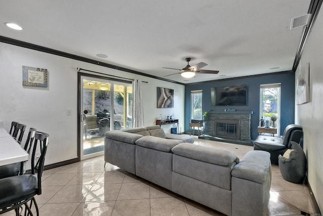 tiled living room with ceiling fan and ornamental molding