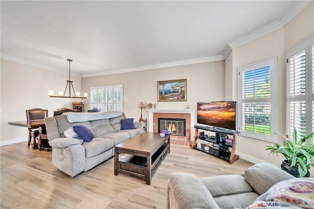 living room featuring ornamental molding, a wealth of natural light, and light hardwood / wood-style flooring