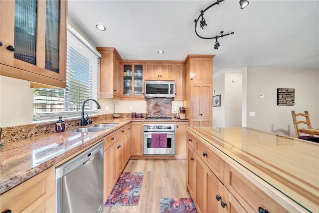 kitchen with sink, light hardwood / wood-style flooring, light stone countertops, light brown cabinetry, and stainless steel appliances