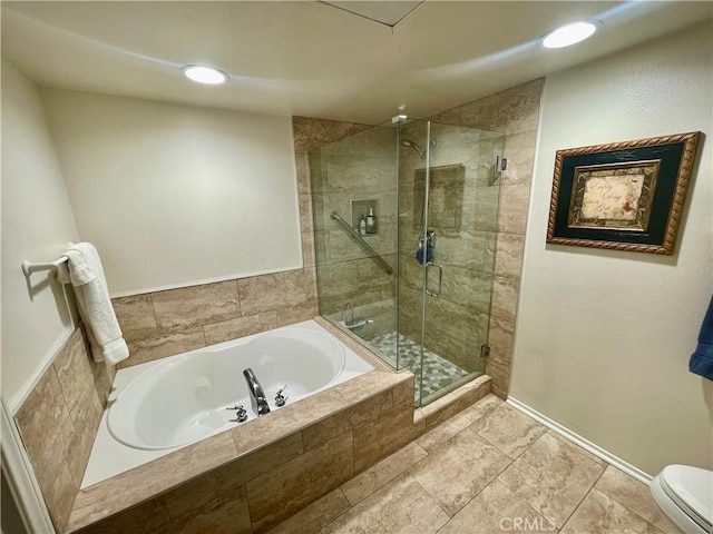 bathroom featuring plus walk in shower and toilet