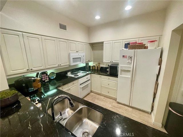 kitchen with white cabinetry, white appliances, and sink