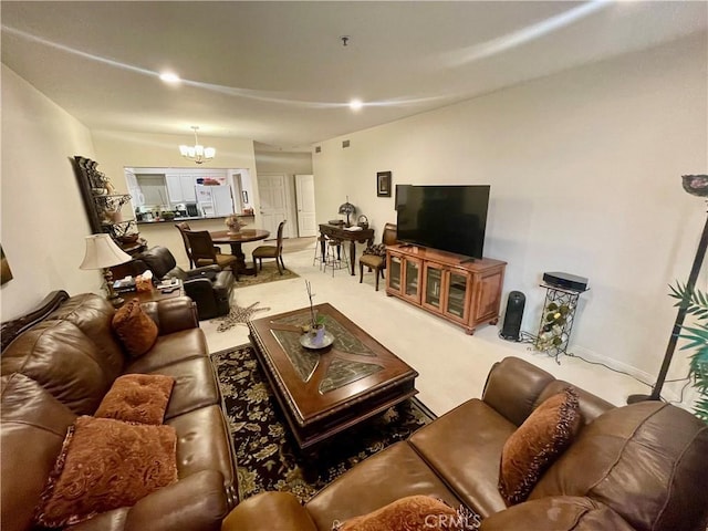 carpeted living room with a chandelier