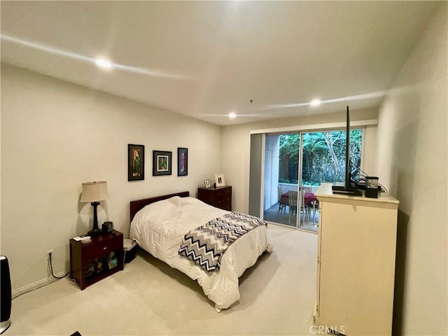 bedroom featuring light carpet and access to outside