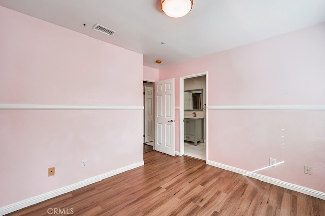 empty room with hardwood / wood-style flooring