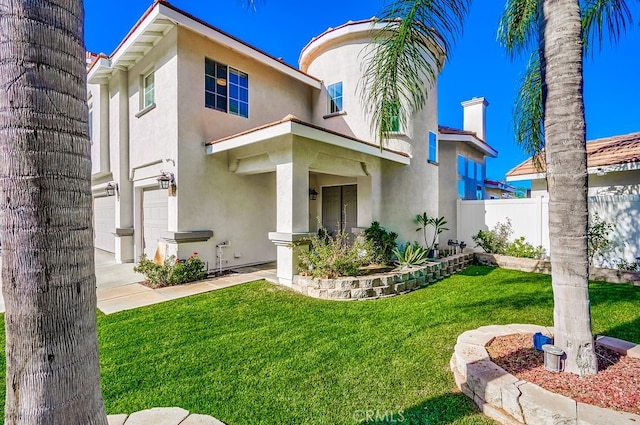 view of front of home featuring a front lawn and a garage